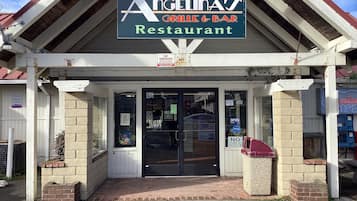 A restaurant named Angelinas Grill & Bar with a sign above the entrance.