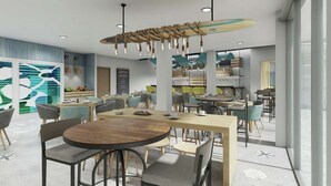 A modern dining area with round tables, chairs, and a surfboard-themed light fixture.