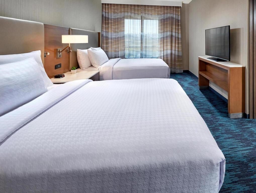 Hypo-allergenic bedding, desk, laptop workspace, blackout drapes