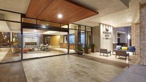 Un hall de hotel con chimenea, zona de estar y un cartel de 'Homewood Suites'.