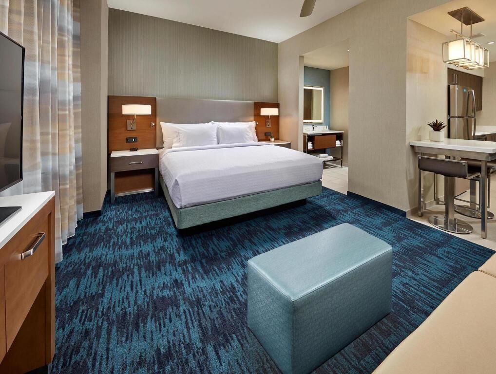 Hypo-allergenic bedding, desk, laptop workspace, blackout drapes