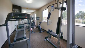 A gym with treadmills, elliptical machines, and weight equipment. - Days Inn & Suites by Wyndham Warner Robins Near Robins AFB (Warner Robins)