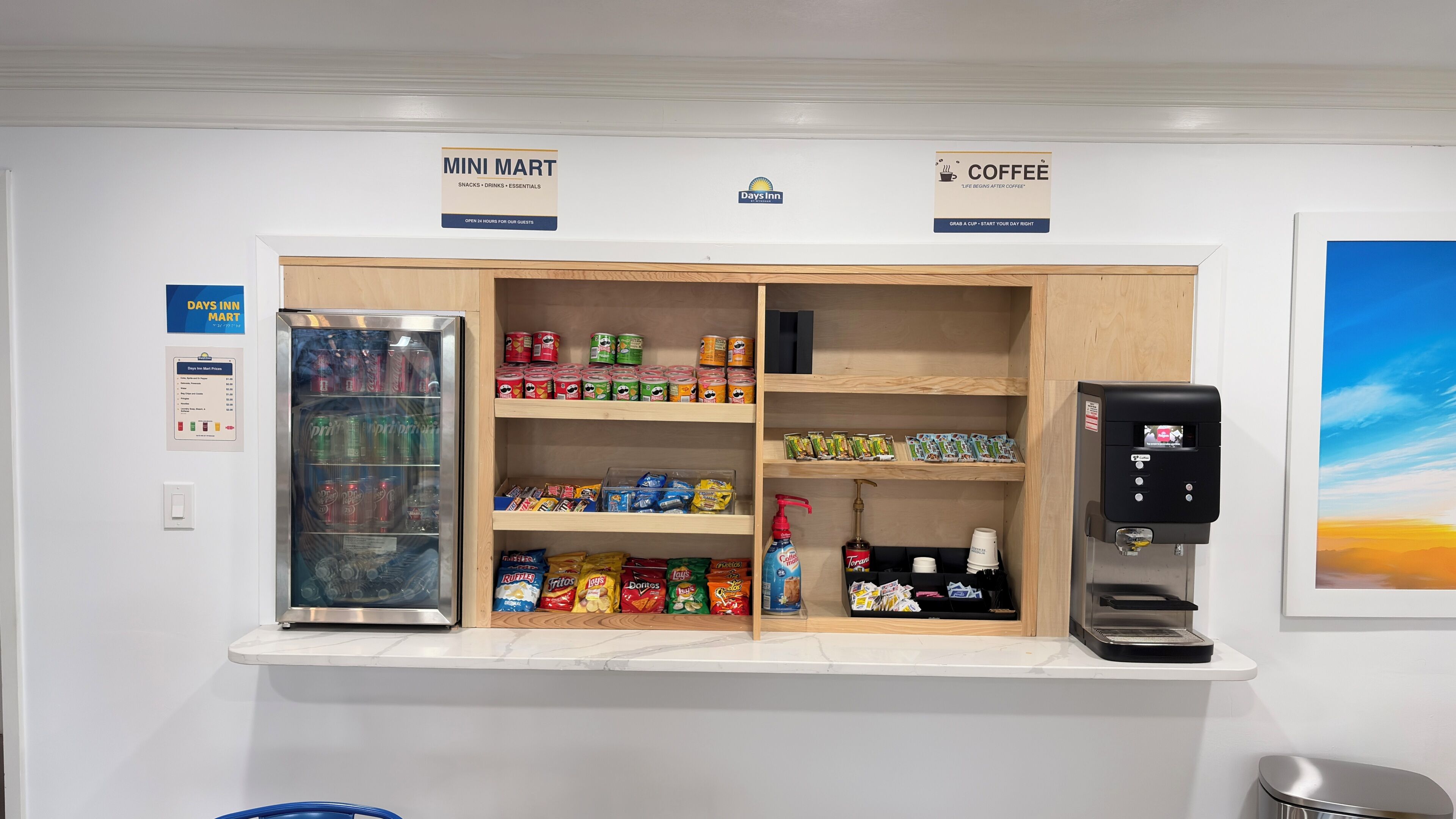 A mini mart with snacks, drinks, and essentials, a coffee station, and a refrigerator with beverages.