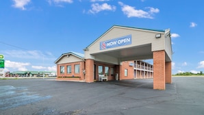 A 6 Now Open gas station with a covered entrance, brick exterior, and a large parking lot. - Motel 6 Metropolis, IL (Metropolis)