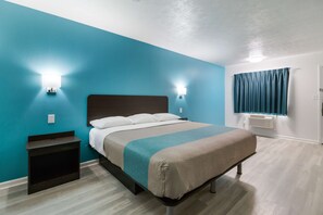 A bedroom with a bed, bedside tables, and a window with curtains. - Motel 6 Metropolis, IL (Metropolis)