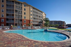 A hotel with a swimming pool, multiple balconies, and a view of the surrounding area. - Westgate Vacation Villas Resort (Kissimmee)