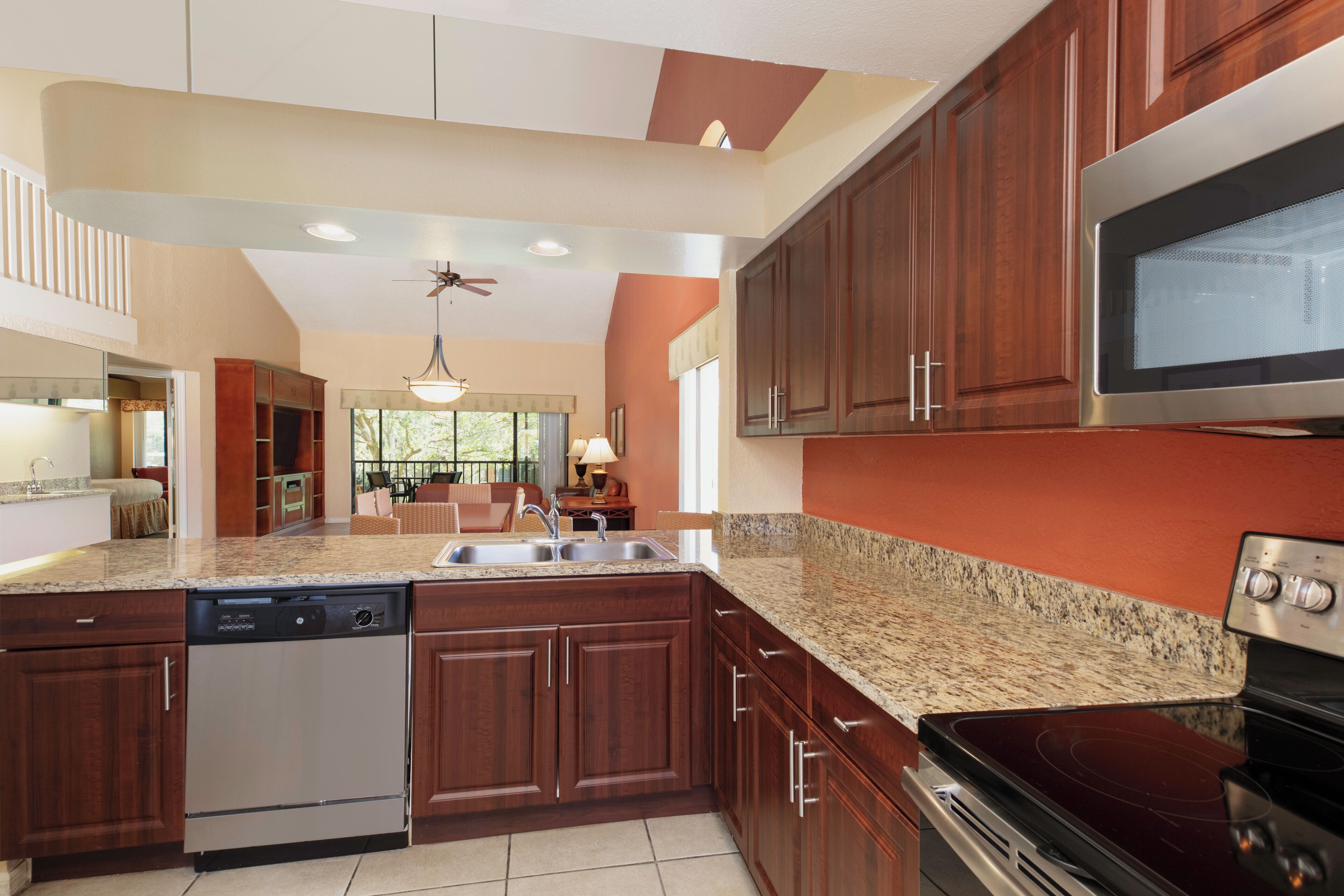 A kitchen with granite countertops, stainless steel appliances, and wooden cabinets.