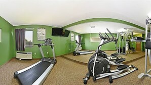 A fitness room with treadmills, elliptical machines, and a stationary bike.