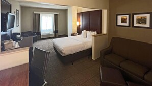 A hotel room with a bed, a desk with a chair, a television, and two framed pictures on the wall. - Comfort Suites Peoria Sports Complex (Peoria)