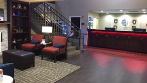 A hotel lobby with a reception desk, a staircase, and seating areas. - Comfort Inn & Suites Peachtree Corners - Norcross (Norcross)