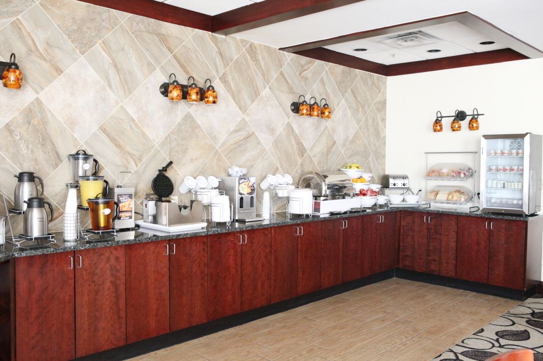 A modern kitchen with granite countertops, stainless steel appliances, and a built-in refrigerator.