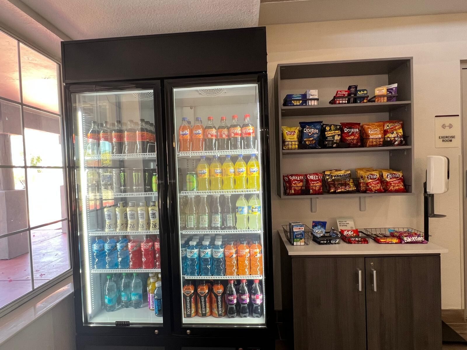 A vending machine with various beverages and snacks, including Fanta, Coca-Cola, Doritos, and chips.