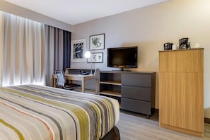 A hotel room with a bed, a desk, a television, and a wardrobe. - Country Inn & Suites by Radisson, Lumberton, NC (Lumberton)