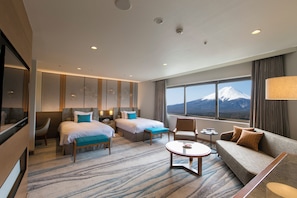 A hotel room with two beds, a sofa, a coffee table, and a TV. - Highland Resort Hotel & Spa (Fujiyoshida)