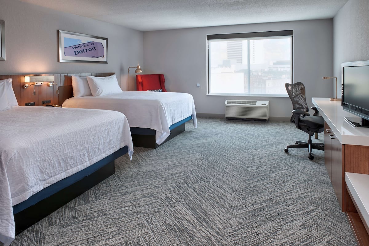 Premium bedding, desk, laptop workspace, blackout drapes