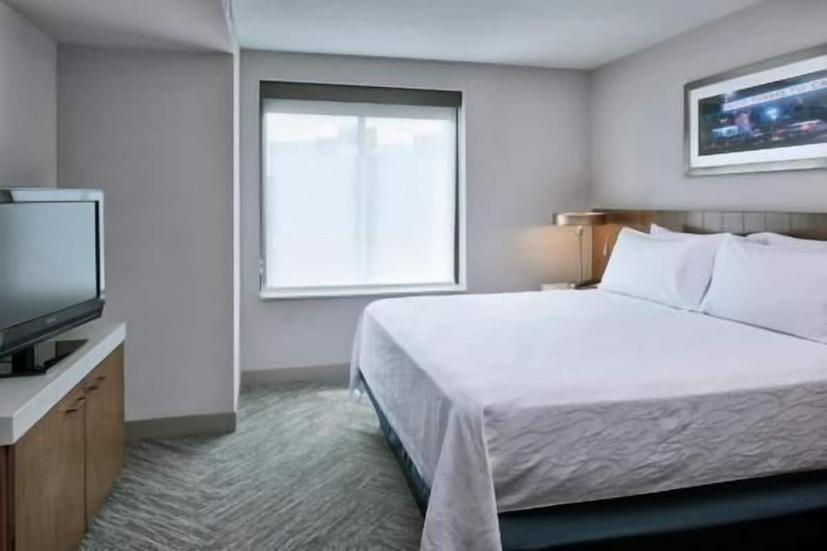 Premium bedding, desk, laptop workspace, blackout drapes