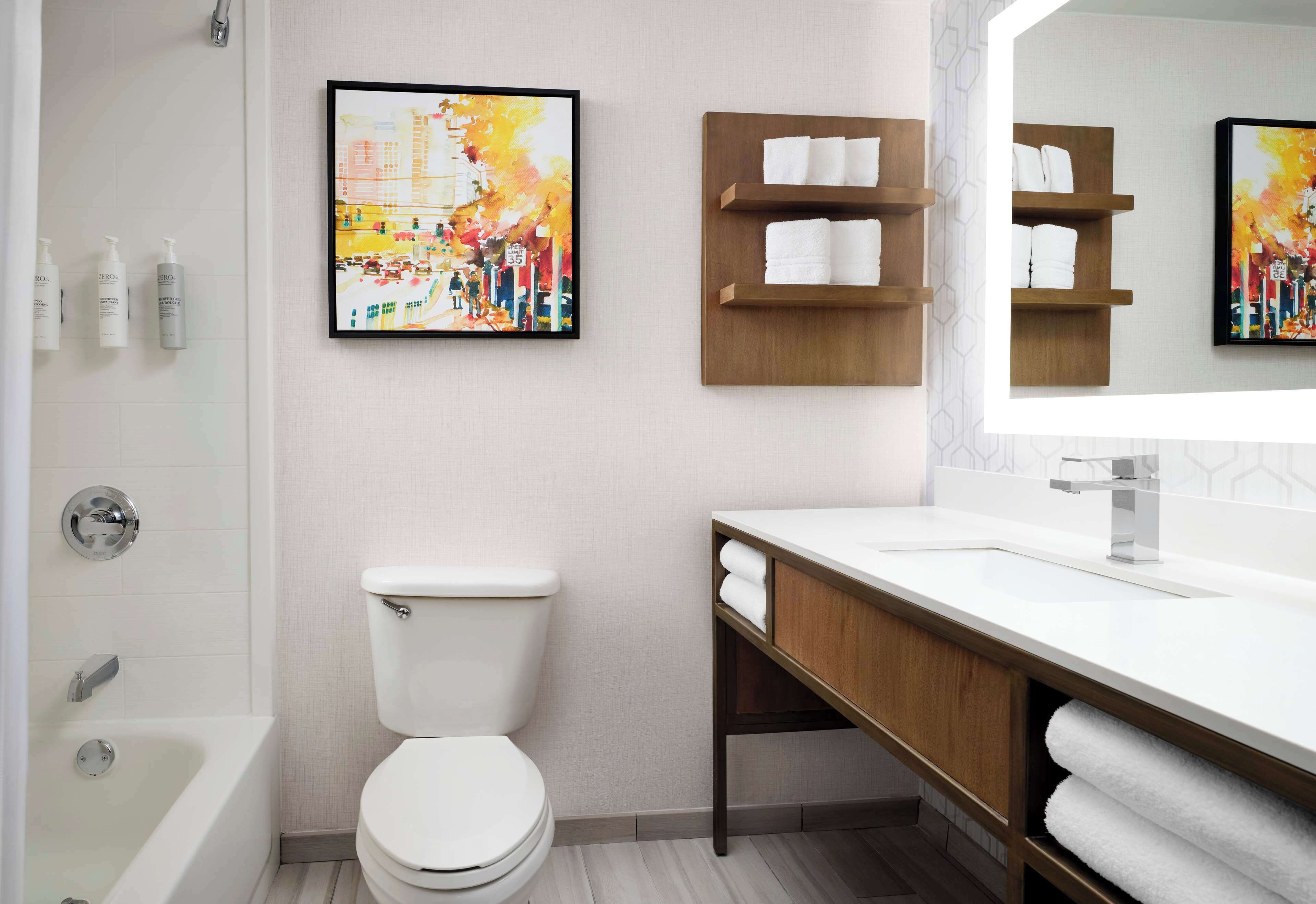 combined shower/bathtub, designer toiletries, hair dryer, towels