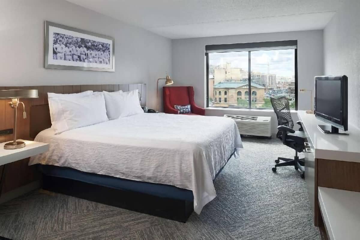 Premium bedding, desk, laptop workspace, blackout drapes