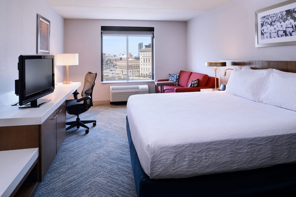 Premium bedding, desk, laptop workspace, blackout drapes