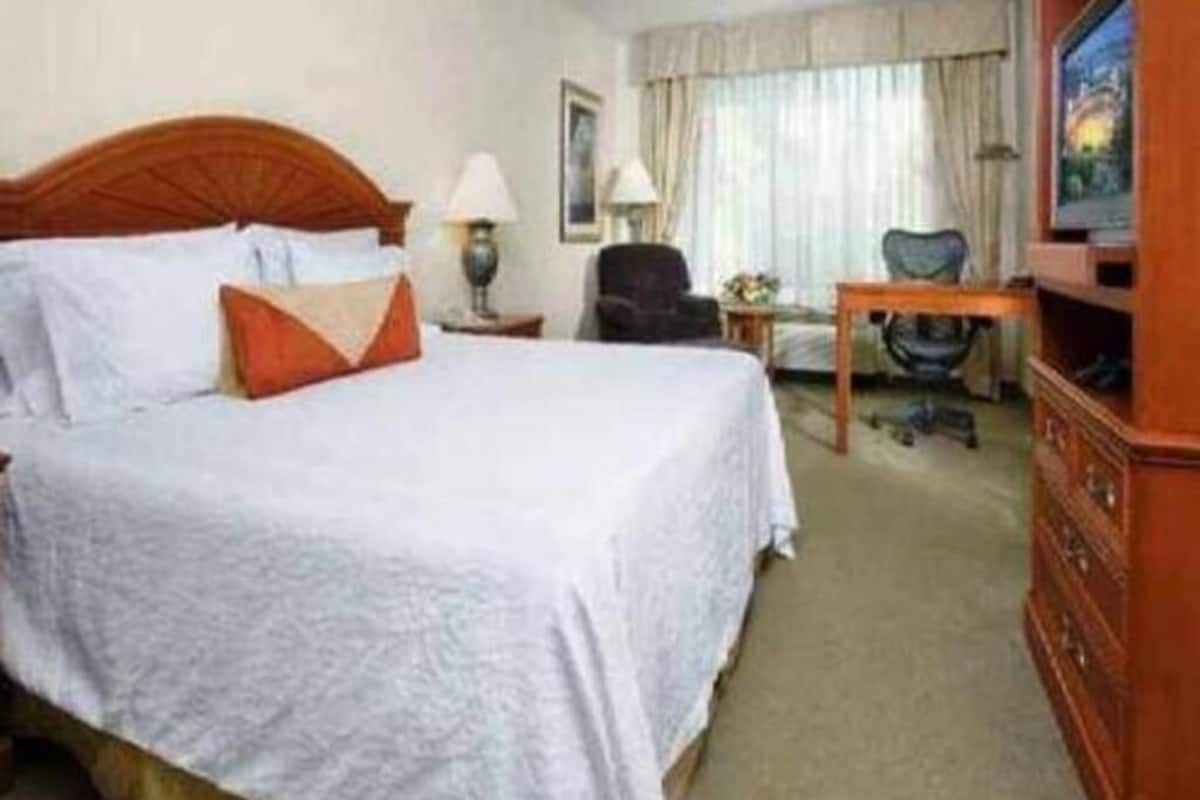 Premium bedding, desk, laptop workspace, blackout drapes