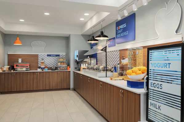 A modern kitchen with a bakery section, a yogurt display, and a sign for Express Start Fastbreak. - Holiday Inn Express Hotel & Suites Richmond-Brandermill by IHG (Midlothian)
