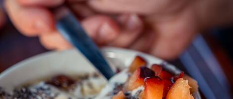 A bowl of food with various toppings.