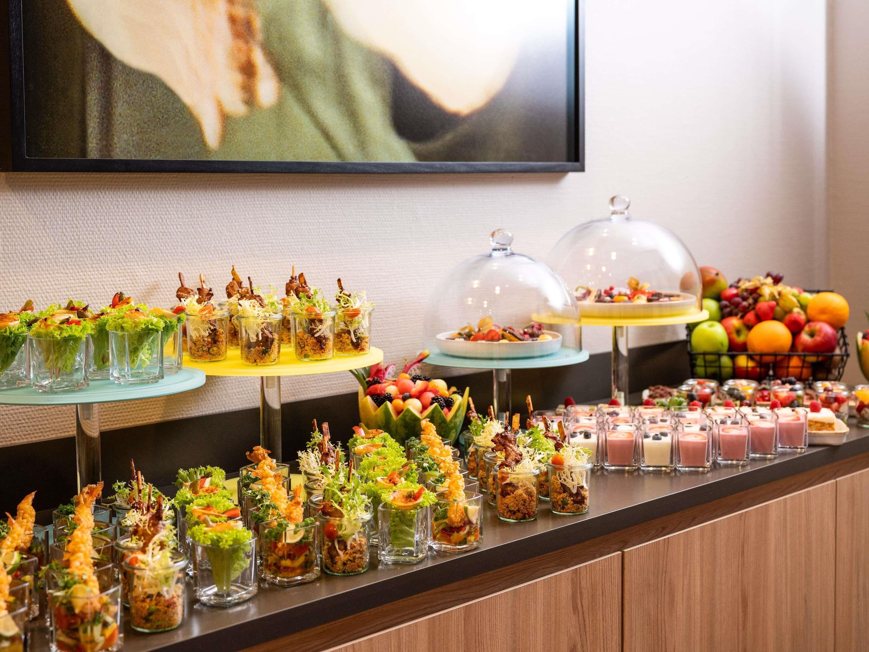 A buffet with various food items, including shrimp, salads, and desserts, displayed on a counter.