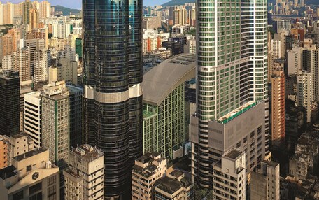 A high-rise building with a modern glass facade and a distinctive curved top.