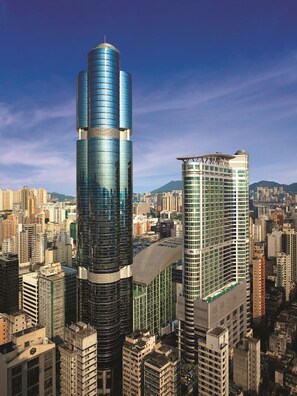 A high-rise building with a modern glass facade and a distinctive curved top. - Cordis, Hong Kong (Kowloon)