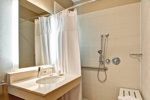 A modern bathroom with a sink, mirror, shower, and toilet. - SpringHill Suites by Marriott Lexington Near the University of Kentucky (Lexington)