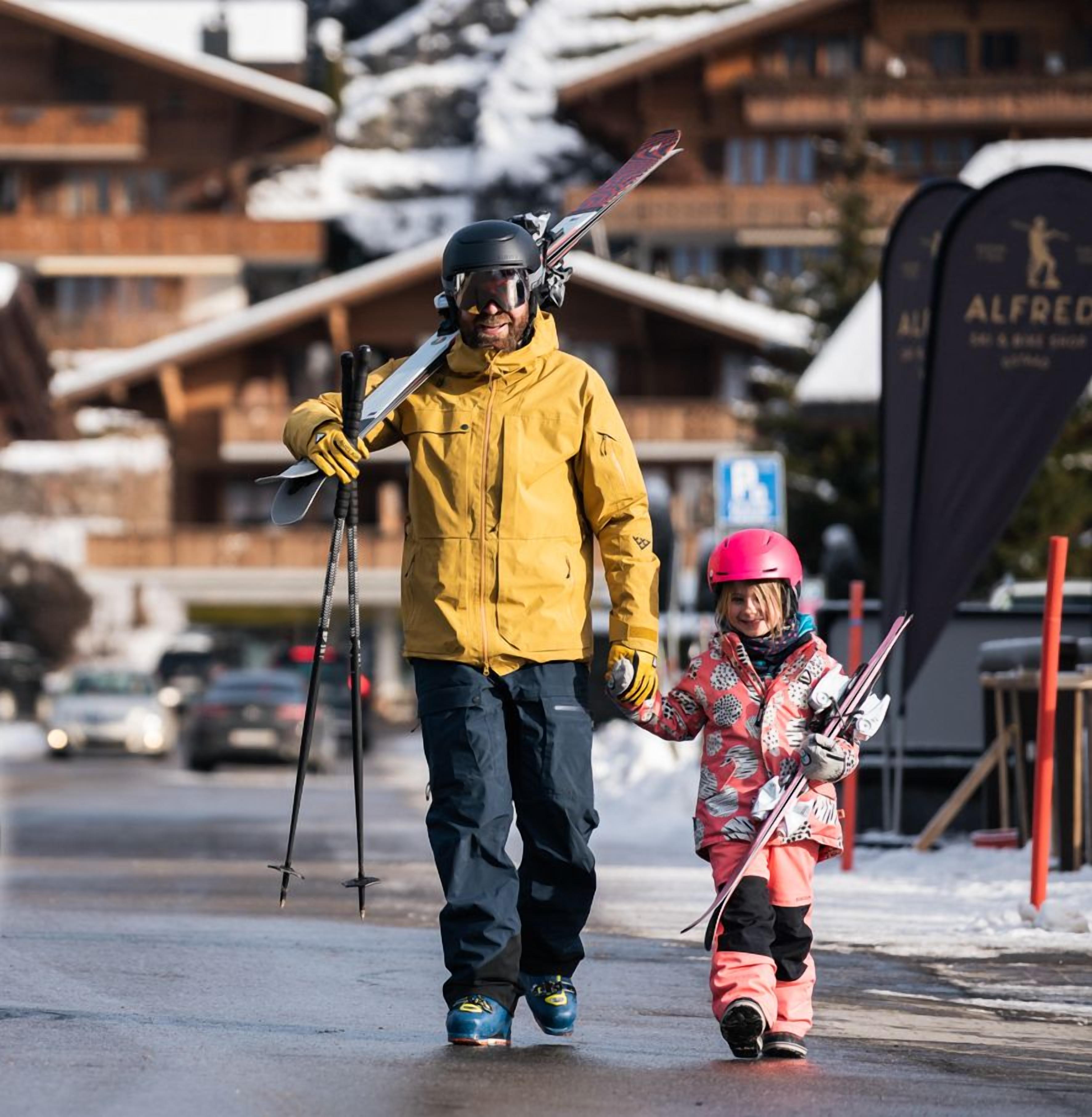 A ski resort with wooden buildings and a sign for 'Alfred'.