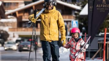 A ski resort with wooden buildings and a sign for 'Alfred'.