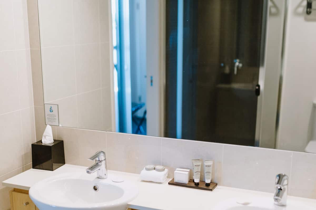 One Bedroom Corner Suite | Bathroom | Shower, free toiletries, hair dryer, towels