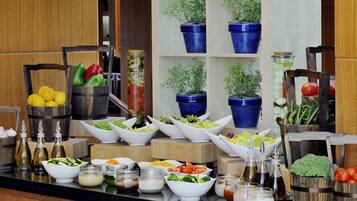 A buffet with various food items and condiments.