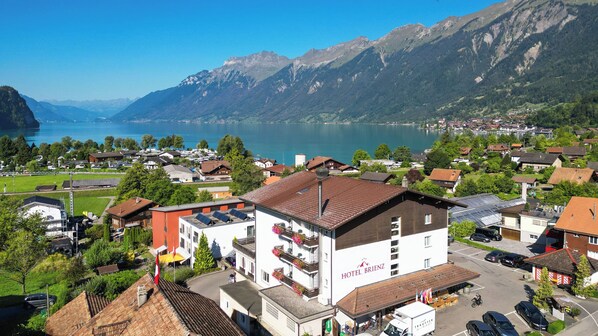 A hotel with a view of a lake and mountains.