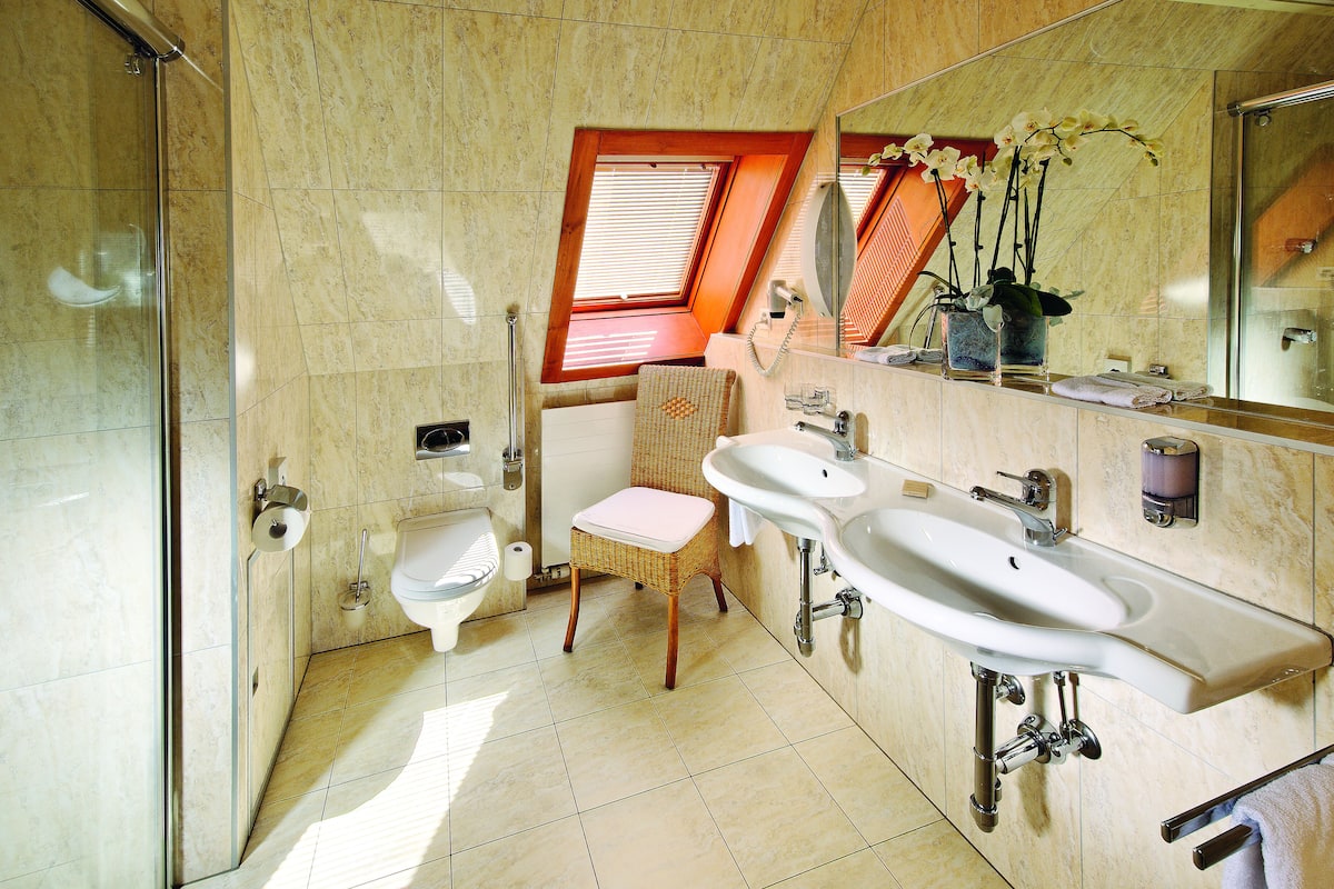 pent suite | bathroom | shower, hair dryer, slippers, towels