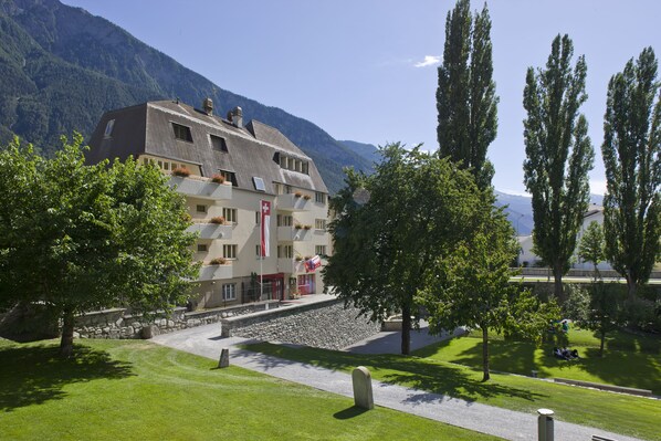Experience the serene Swiss charm of this traditional hotel, surrounded by lush gardens and a beautifully manicured lawn.