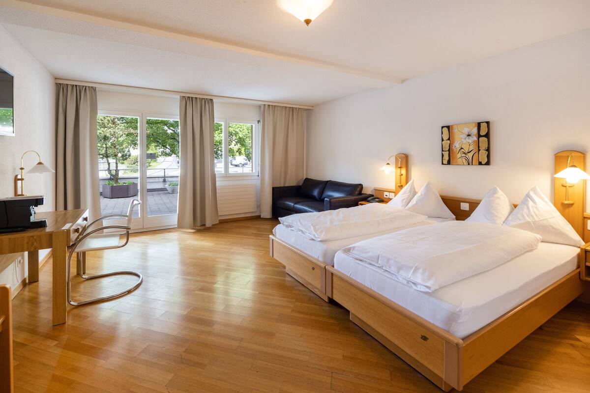 twin room with mountain view (incl. city tax) | in-room safe, desk, laptop workspace, blackout curtains
