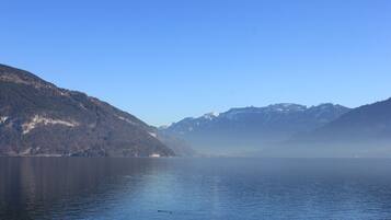 A calm lake with mountains in the background.