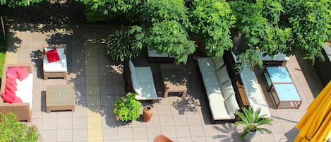 An outdoor patio area with multiple seating options including sofas, chairs, and a table.