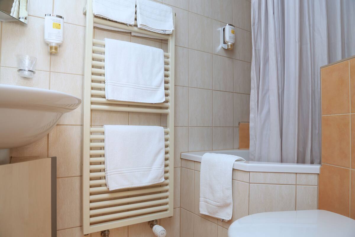 deluxe quadruple room | bathroom | hair dryer, towels