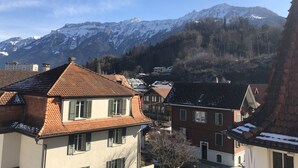 A residential area with traditional European architecture, featuring red-tiled roofs and white walls. - Crystal Interlaken (Interlaken)