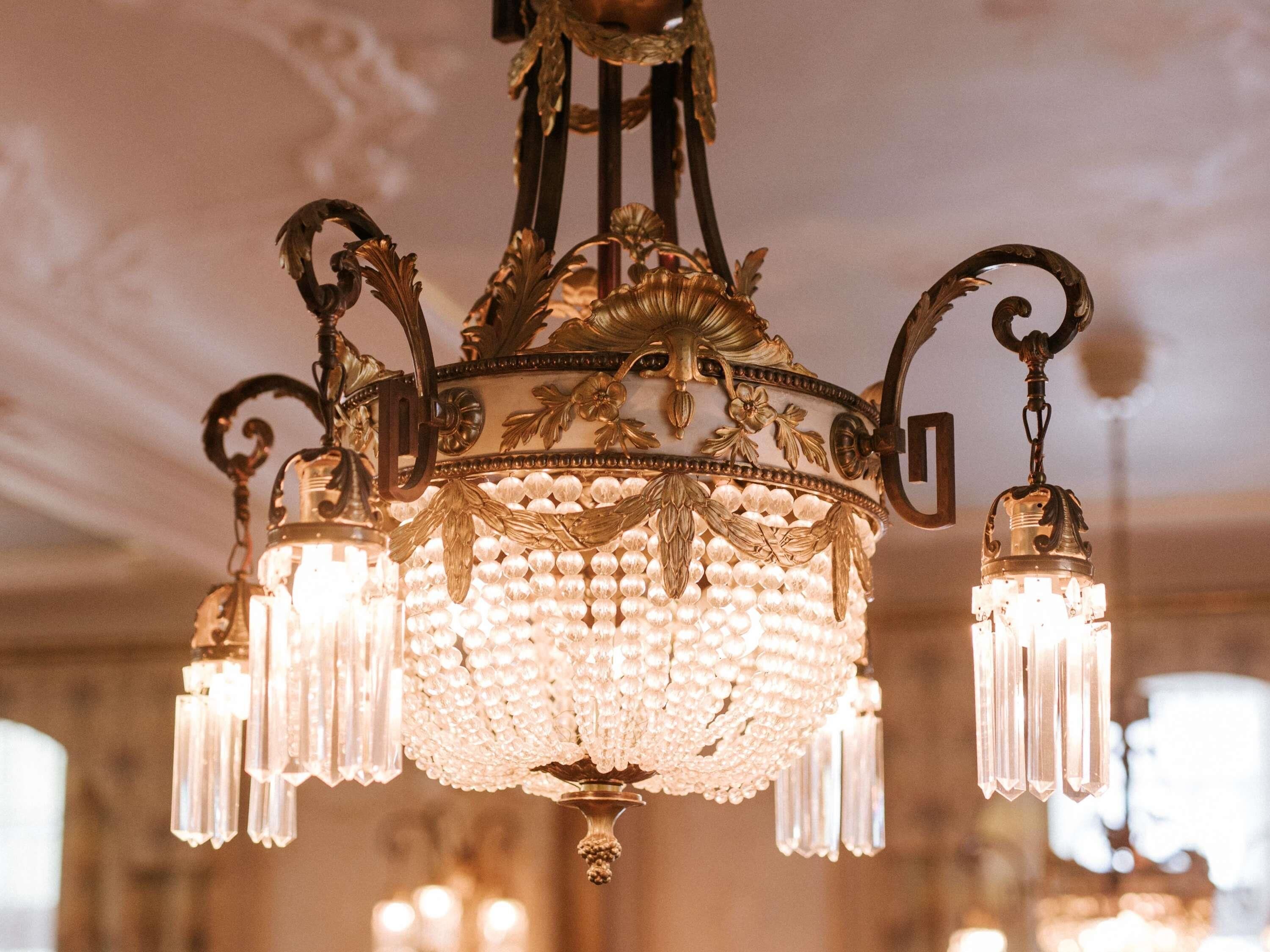 A chandelier with multiple crystal elements and ornate metalwork.