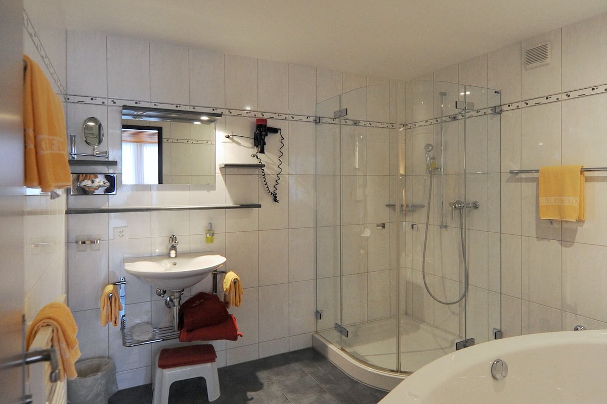 junior suite (deluxe south) | bathroom | shower, hair dryer, towels, soap