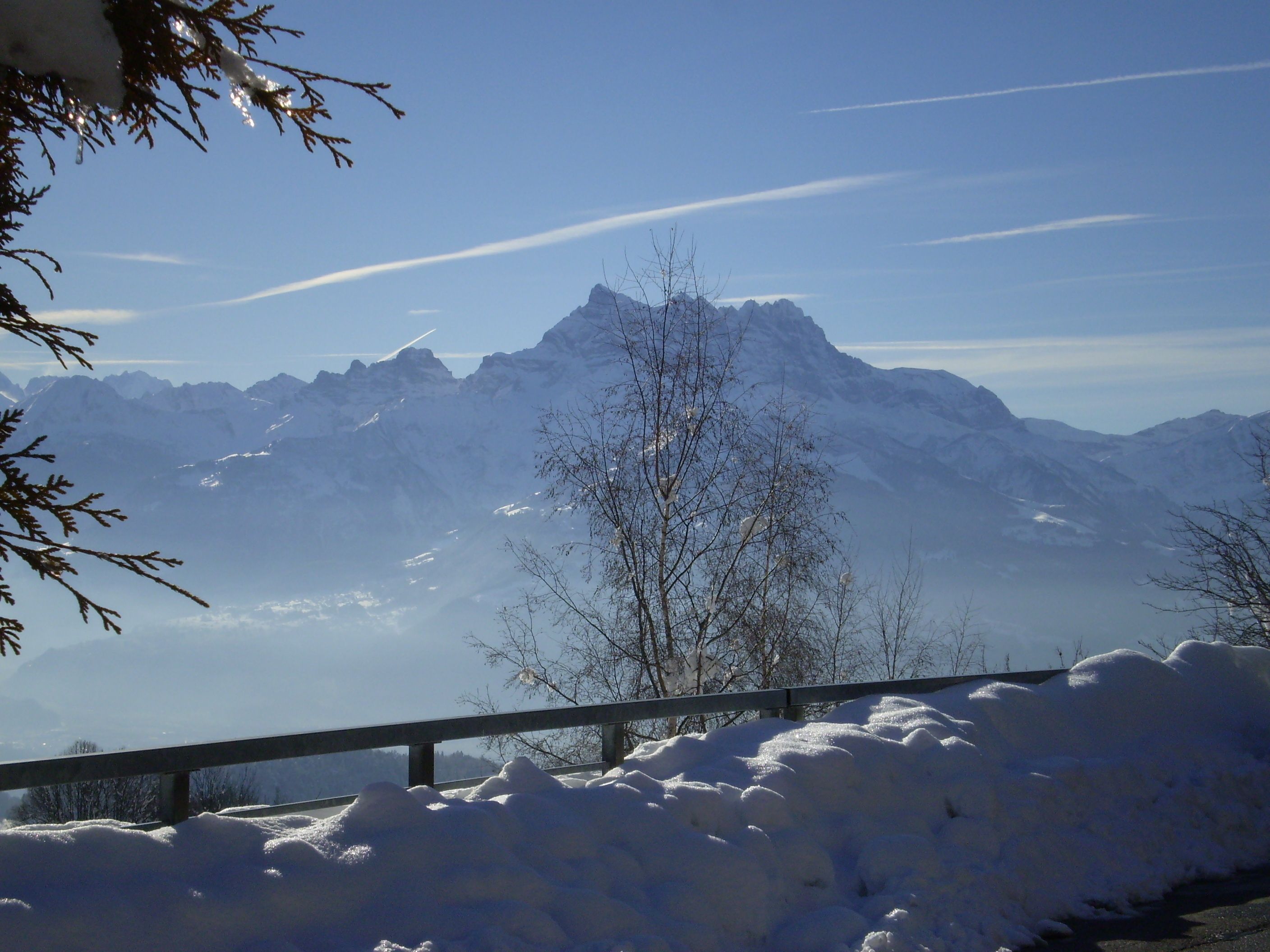 A snow-covered mountain landscape with a clear sky.