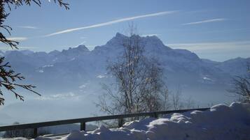 A snow-covered mountain landscape with a clear sky.
