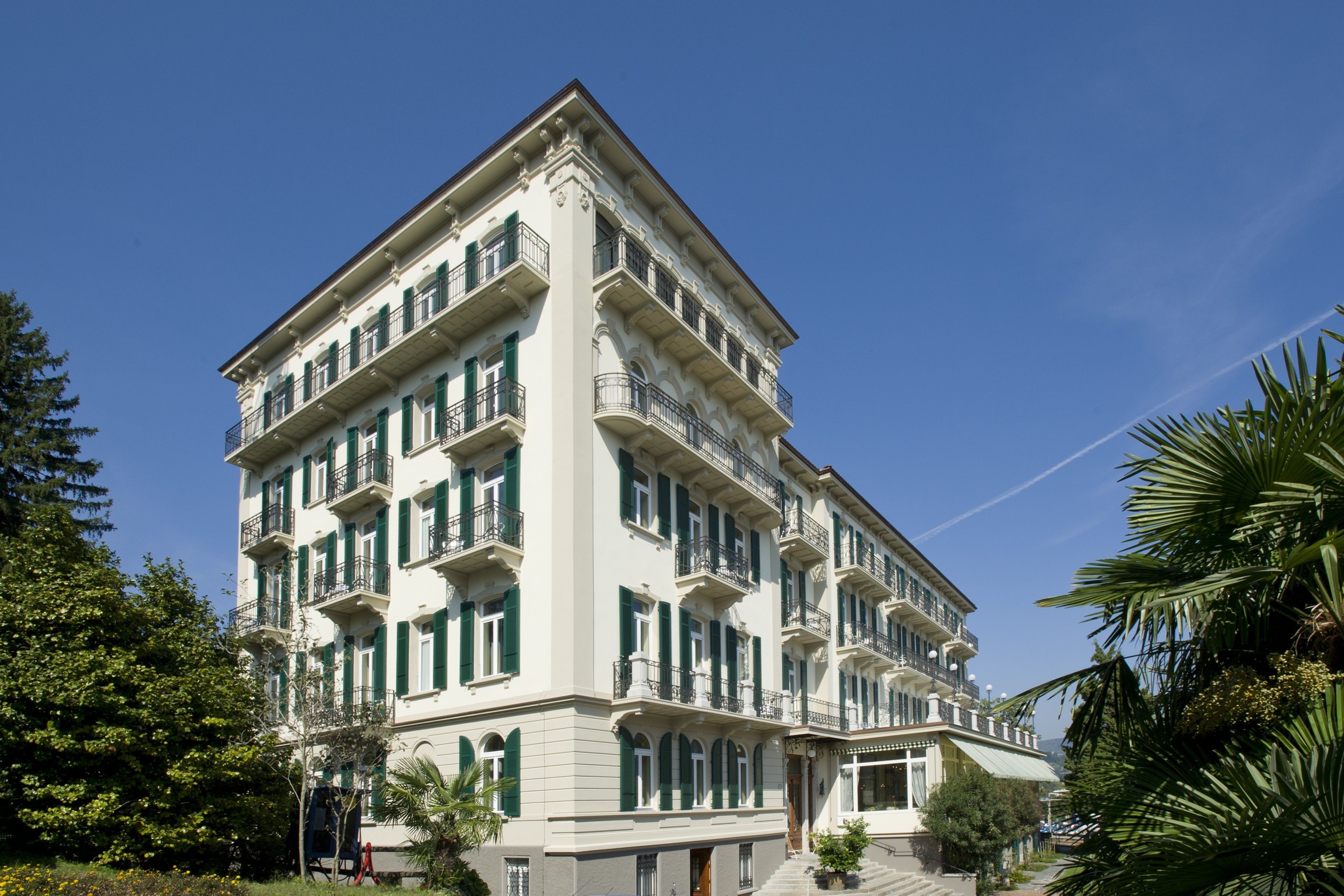 A multi-story building with balconies, large windows, and a classic architectural style.