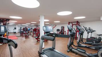 A gym with treadmills, ellipticals, and weight machines.
