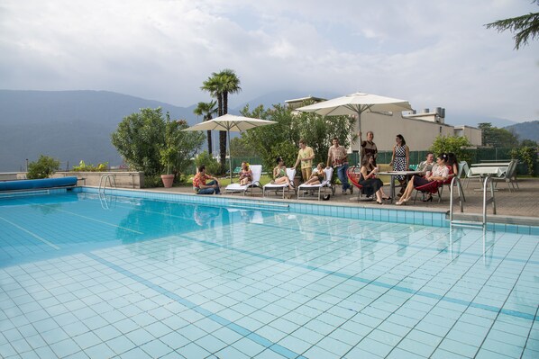 Seasonal outdoor pool, pool umbrellas, pool loungers