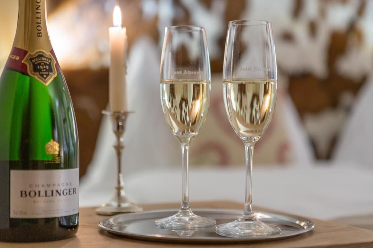 A bottle of Bollinger champagne and two glasses on a tray.